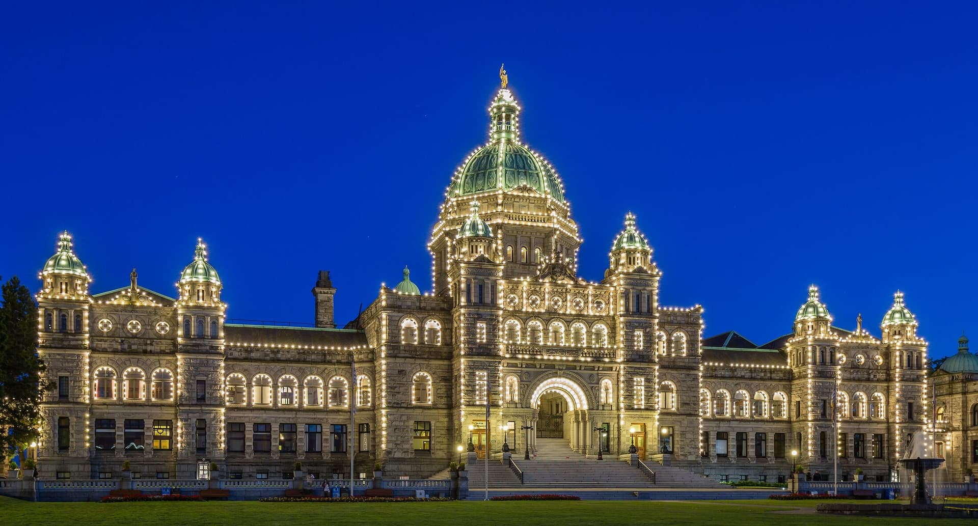 The British Columbia Parliament Buildings in Victoria, lit at blue hour.
