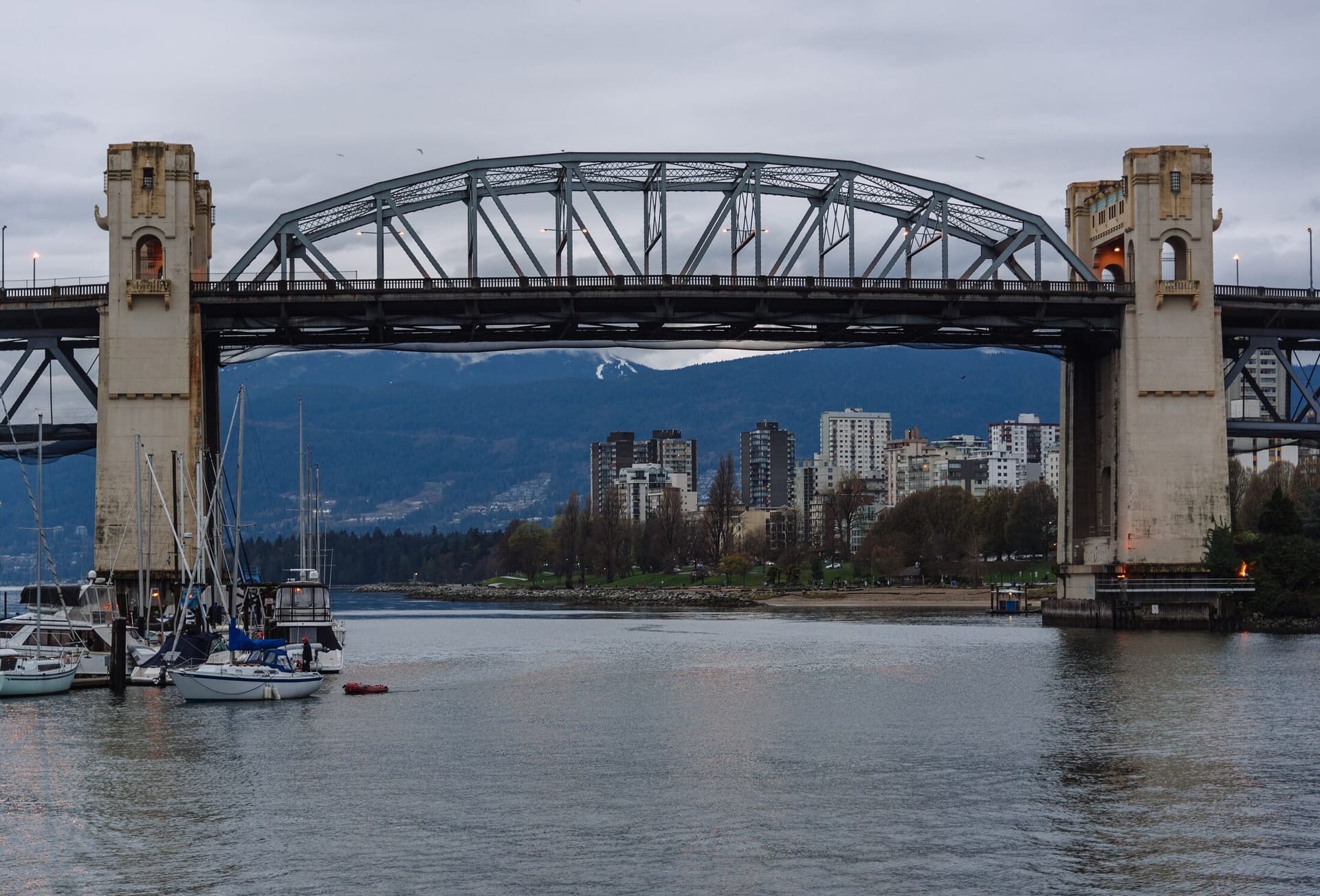 The Burrard Bridge framed from False Creek, with the West End towers beyond.