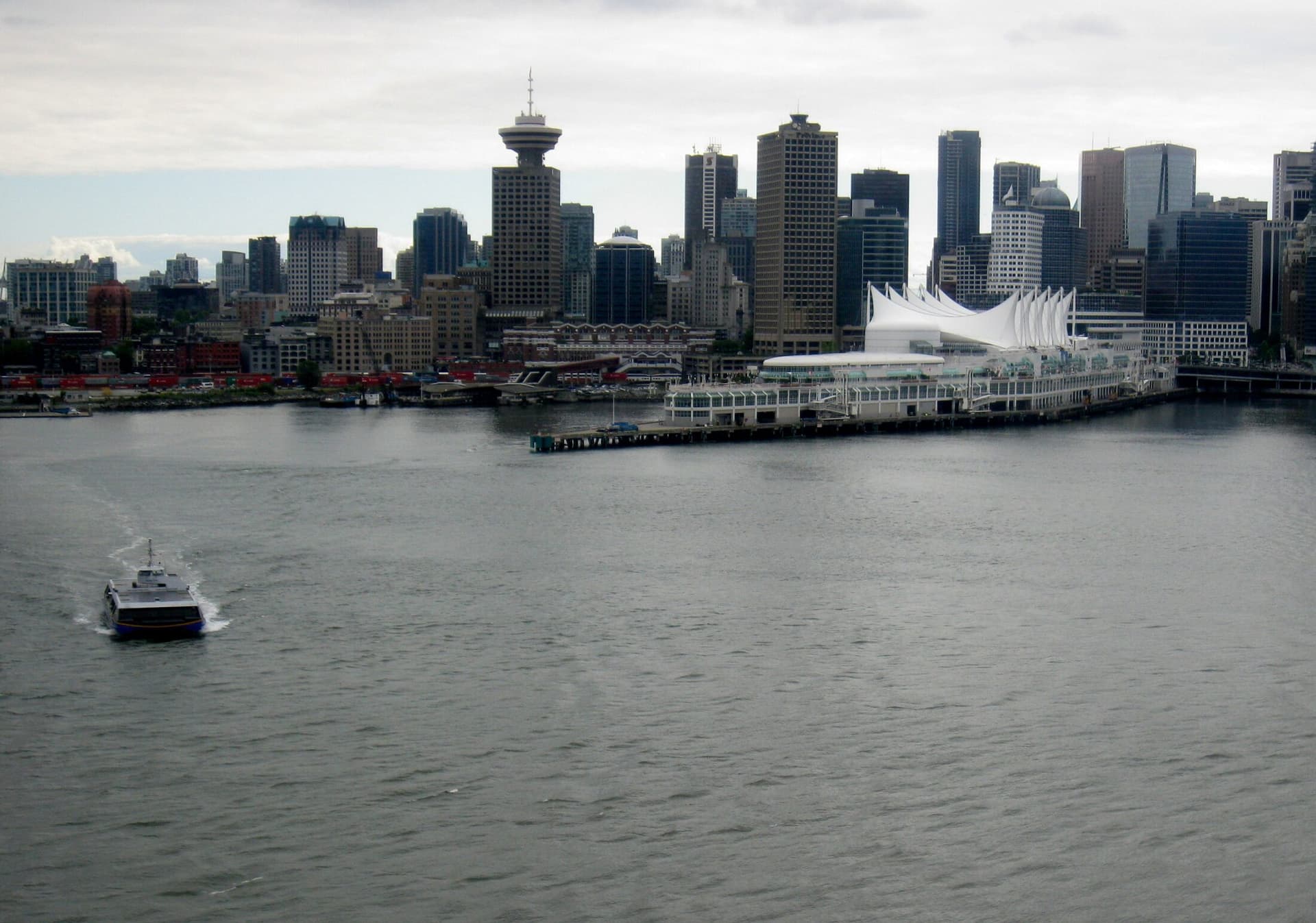 A SeaBus crossing Burrard Inlet in front of the downtown Vancouver skyline.