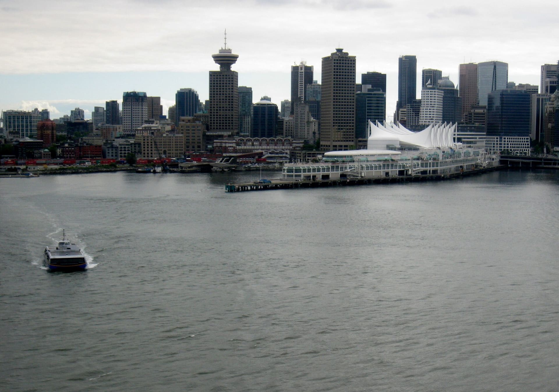 A SeaBus crossing Burrard Inlet in front of the downtown Vancouver skyline.