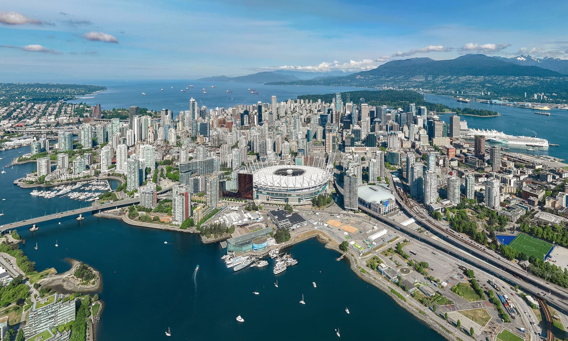 Aerial view of downtown Vancouver, False Creek and the North Shore mountains.