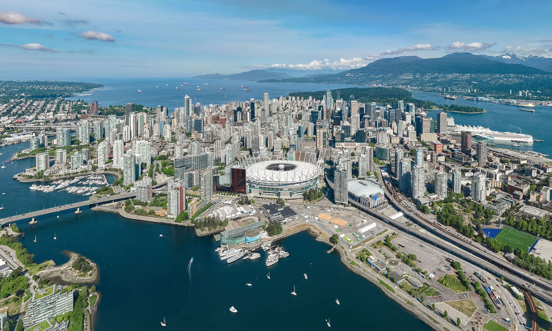 Aerial view of downtown Vancouver, False Creek and the North Shore mountains.