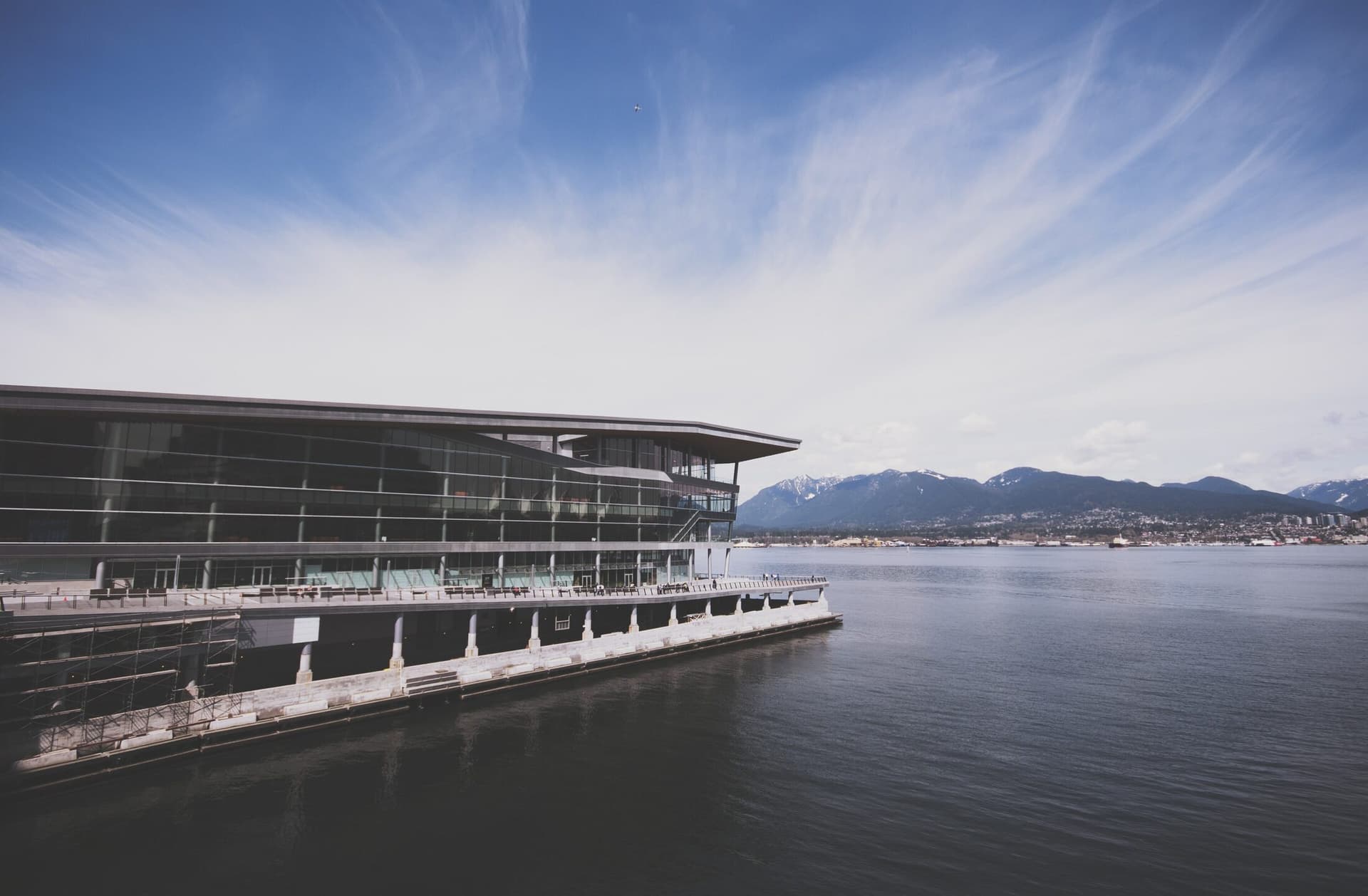 The Vancouver Convention Centre seen from the water under a wide open sky.