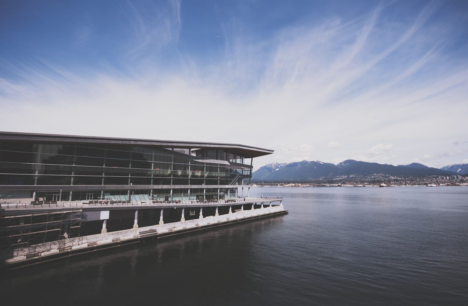 The Vancouver Convention Centre seen from the water under a wide open sky.